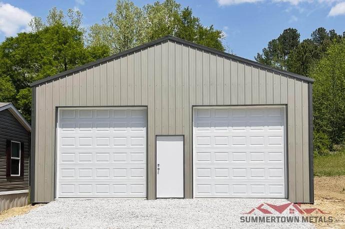 30x40x12 garage with gray siding, darker trim, and two white garage doors