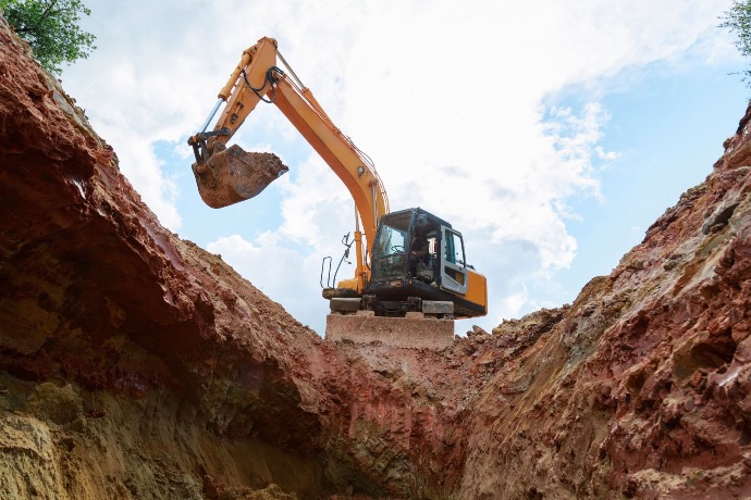 Excavation process using large crane or digging equipment to ensure proper depth and stability