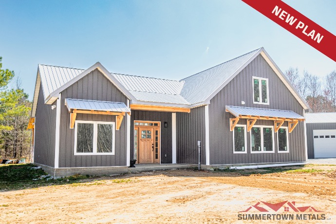 Buffalo Run barndominium resembling suburban house with dark siding, white trim, and light gray roof